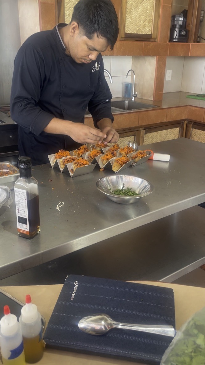 Private chef plating dishes in the resort kitchen
